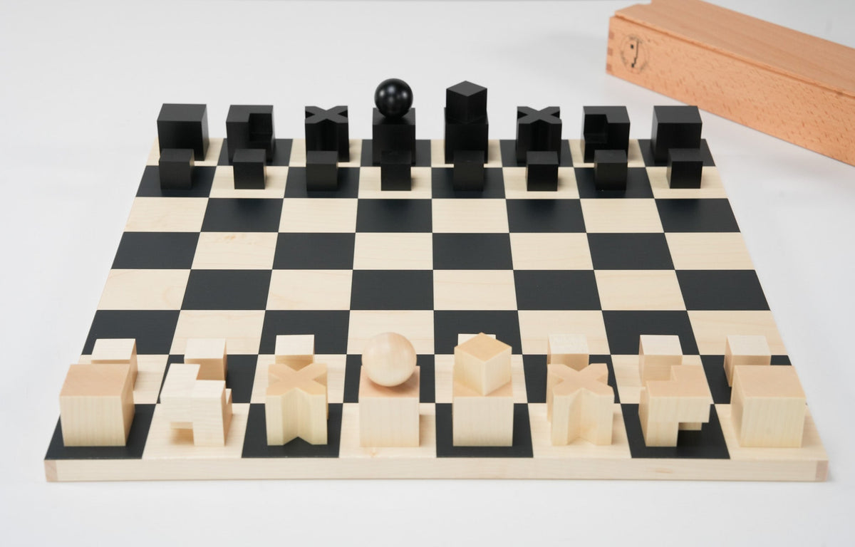 Bauhaus Chess Set by Naef with geometric maple pieces on a borderless board