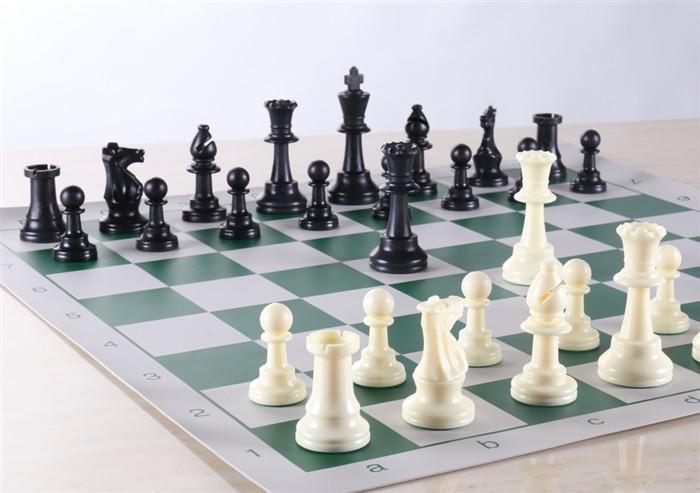 Heavy club chess set with roll-up board and weighted pieces.